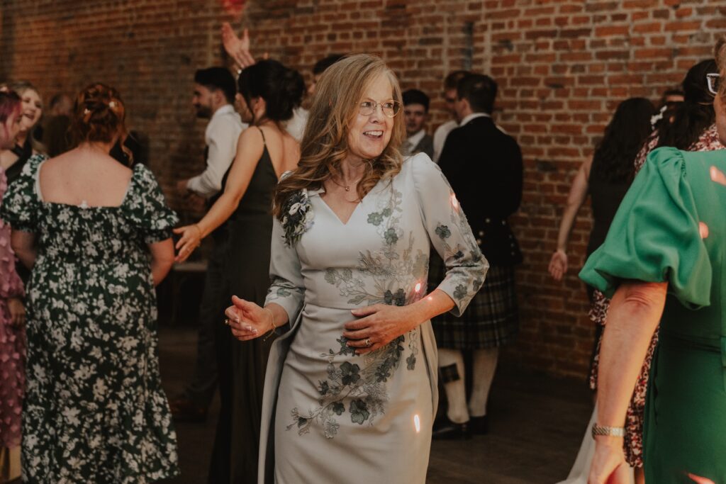 Wedding guests cheering around dancefloor at Copdock Hall celebration