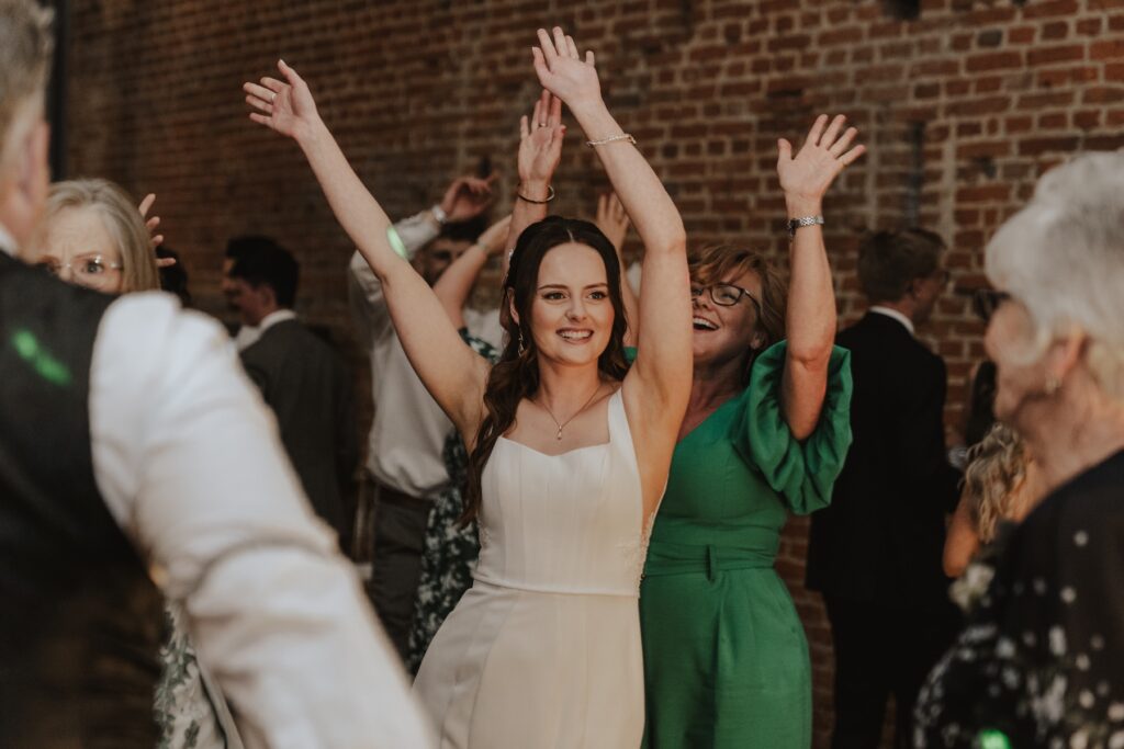 Bride and groom sharing romantic moment during first dance in Suffolk barn