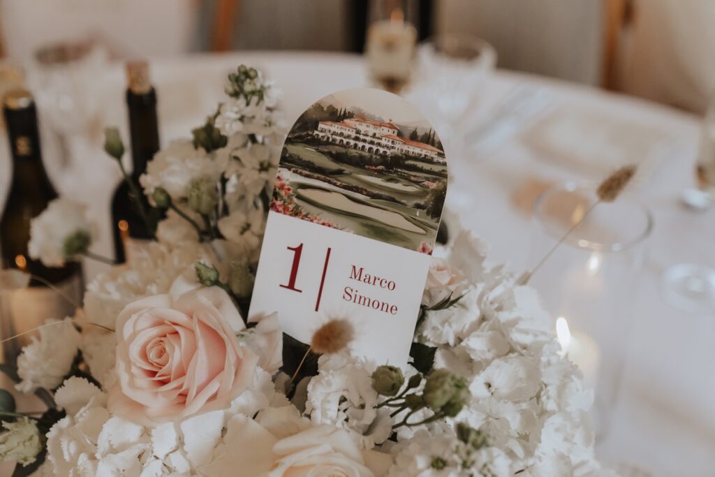 Golf-themed table names and elegant draping inside Great Barn