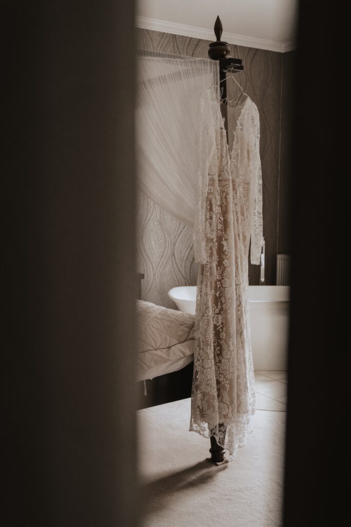 Bride's dressing hanging up in bridal suite at Godwick Hall Barn