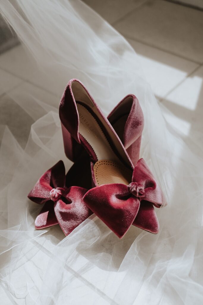 Bridal details including pink shoes and lace dress at Godwick Hall wedding