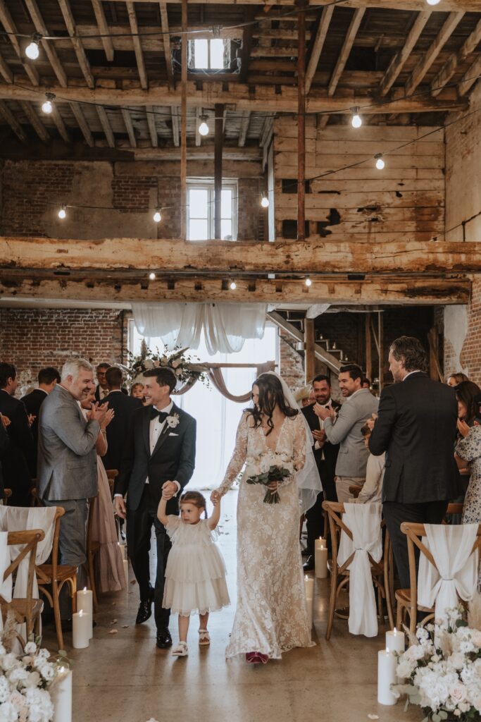 Guests watching emotional wedding ceremony at Godwick Hall Great Barn