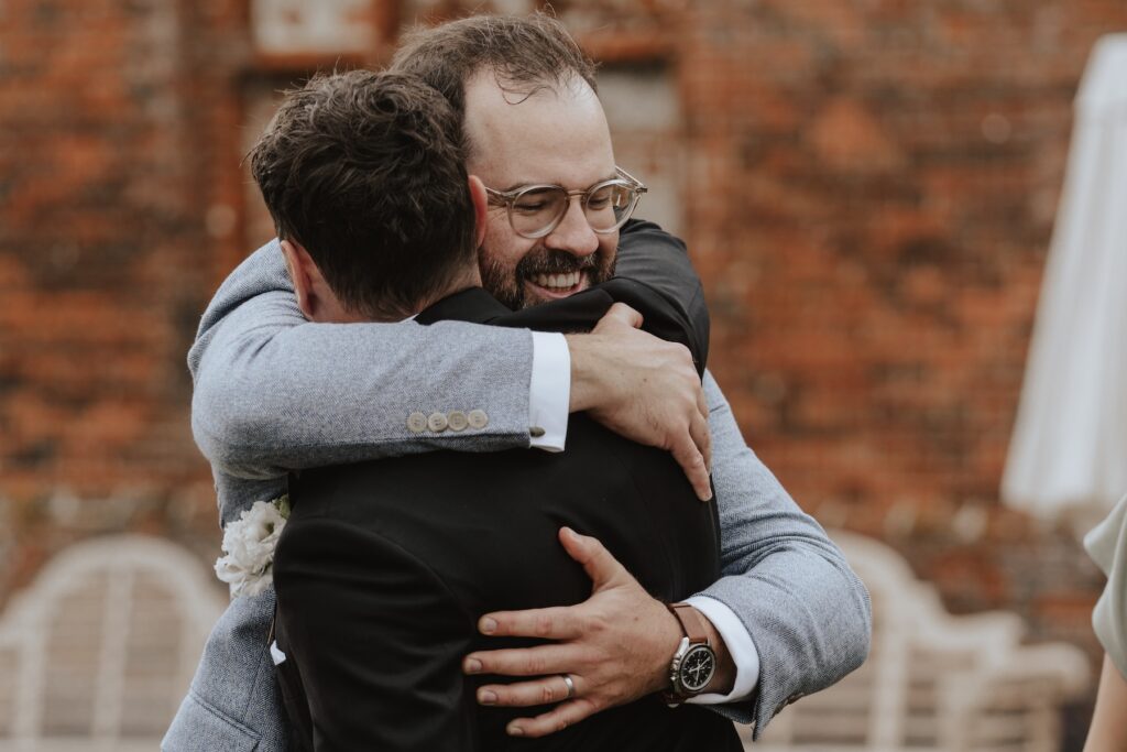 Relaxed drinks reception on terrace at Godwick Hall Norfolk