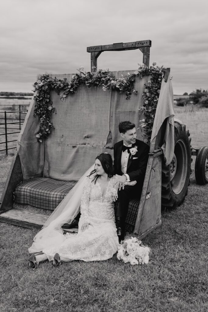 Tractor wedding photos of the couple at Godwick Hall in Norfolk