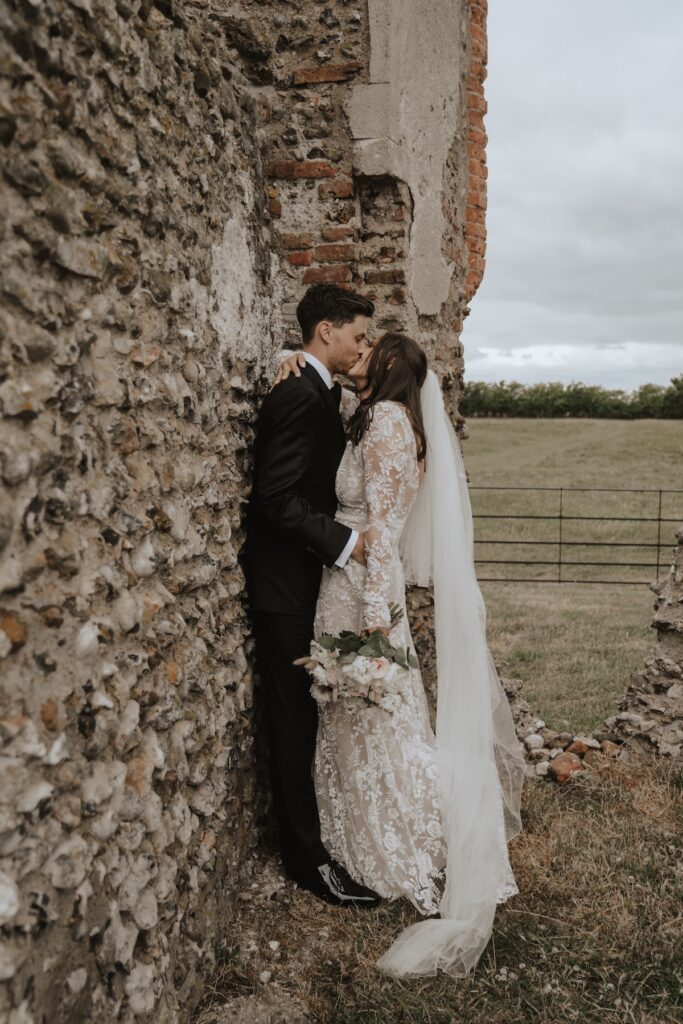 Godwick hall bride and groom on their wedding day sharing a kiss