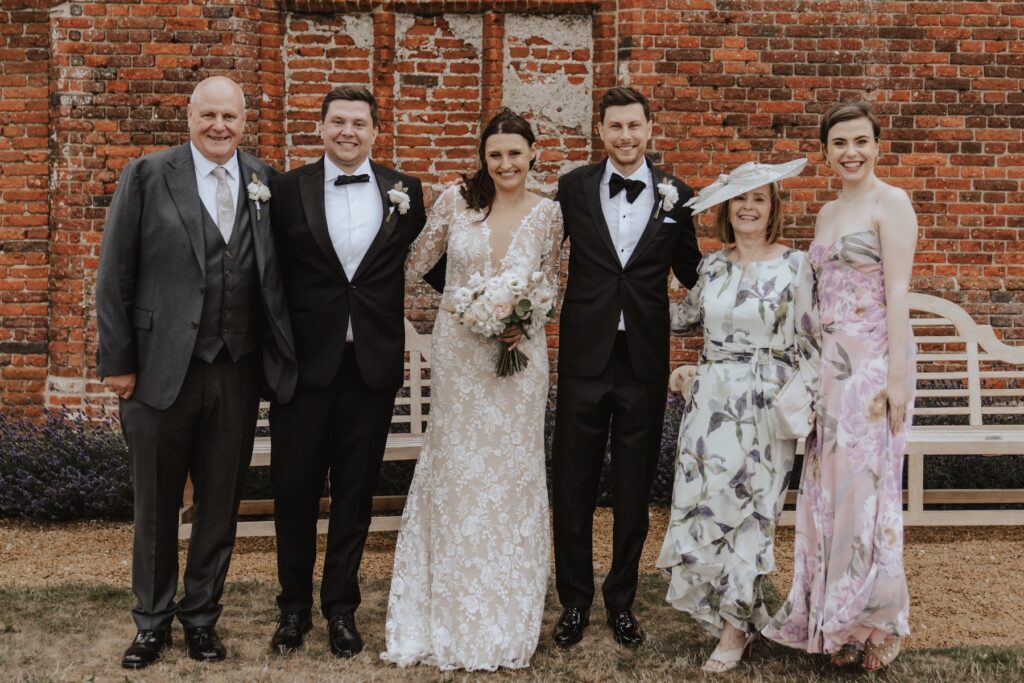 Family portraits at Godwick Hall outside the great barn