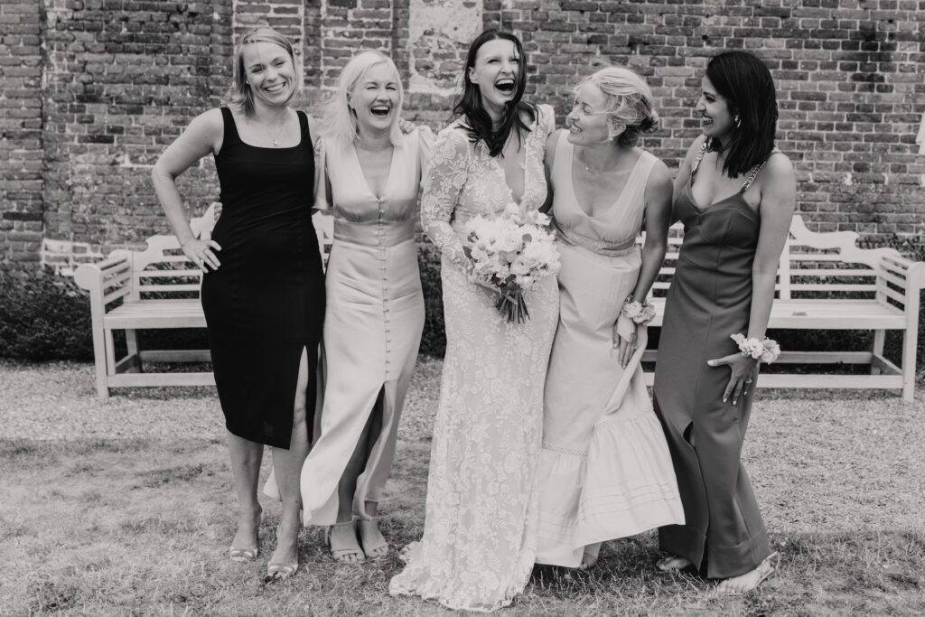 Fun friend photos during drinks reception at Godwick Hall by Norfolk wedding photographer