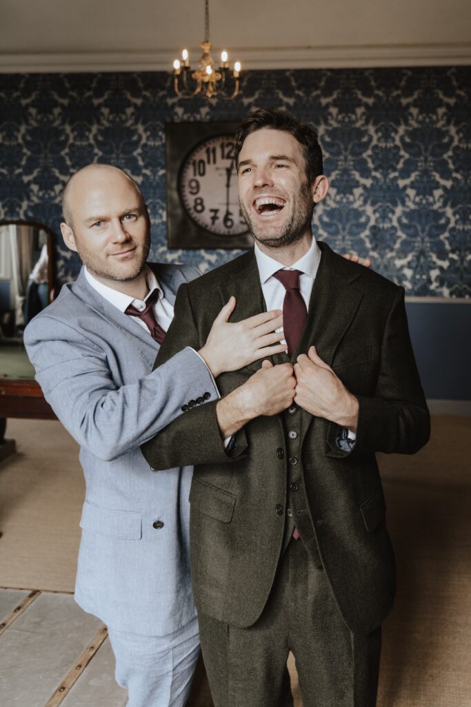 Suffolk wedding photographer capturing the groom getting his jacket on