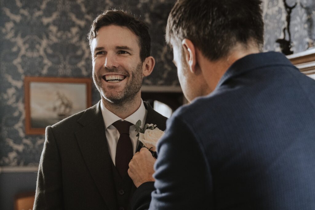 Hengrave Hall wedding photographer capturing grooms prep