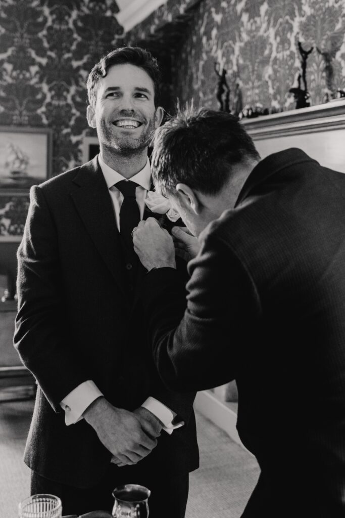 The groom getting ready in the wedding suite at Hengrave Hall