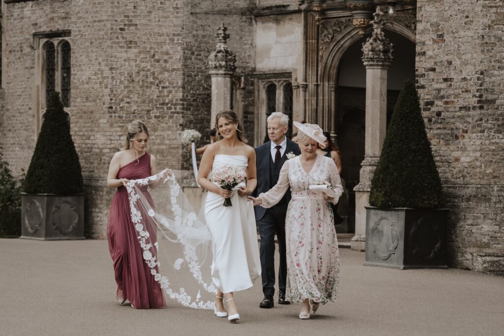 The bride walking to the chapel from Hengrave Hall in Suffolk