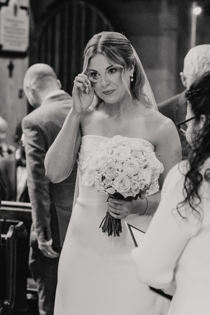 An emotional bride after walking down the aisle at Hengrave Hall