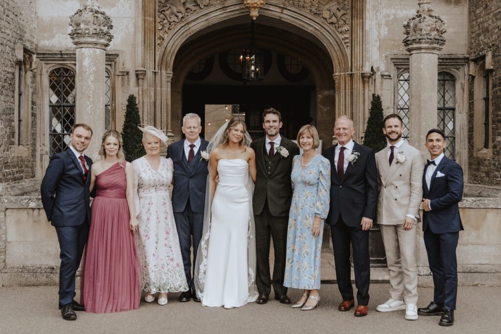 Family group photo with Hengrave Hall’s grand façade in the background