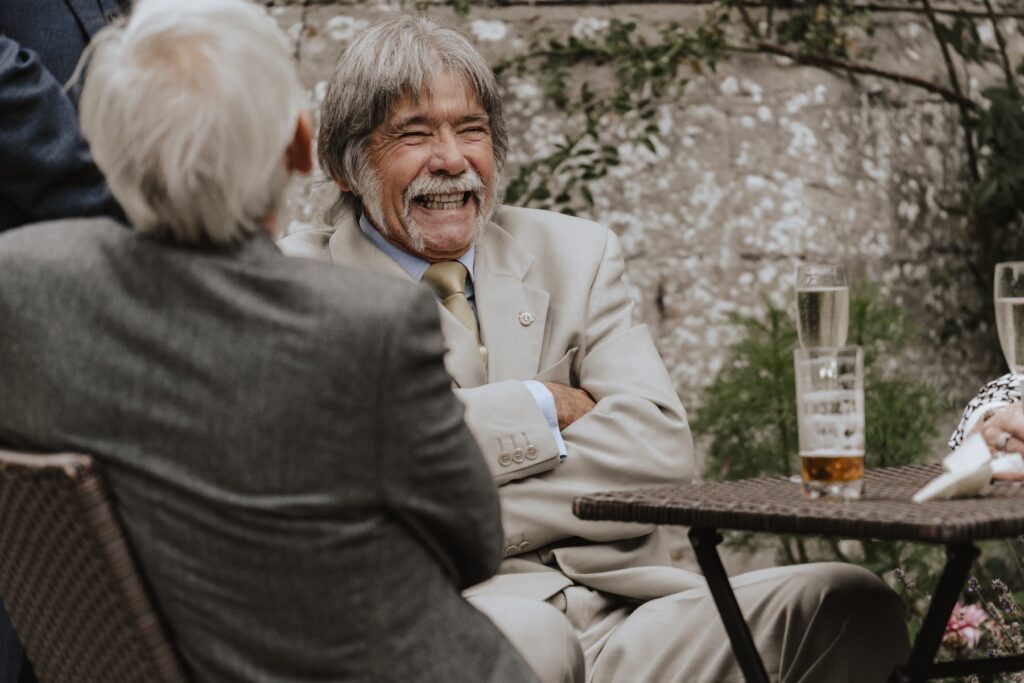 Group of guests gathered under parasols on the terrace