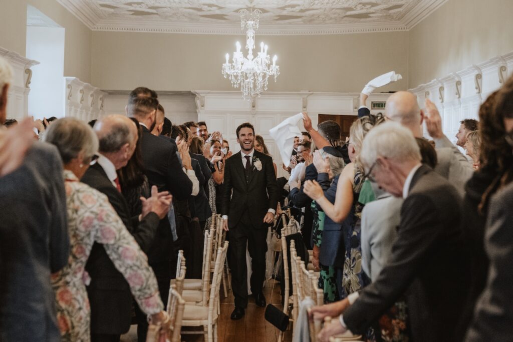 Guests cheering as the couple greet them during the receiving line