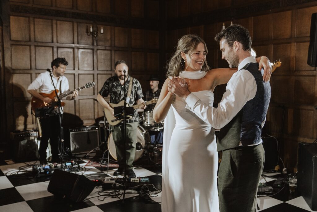 Guests clapping and cheering as the couple take the floor