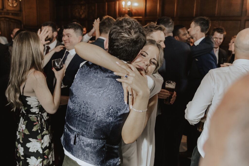 Guests dancing and laughing on the floor under fairy lights