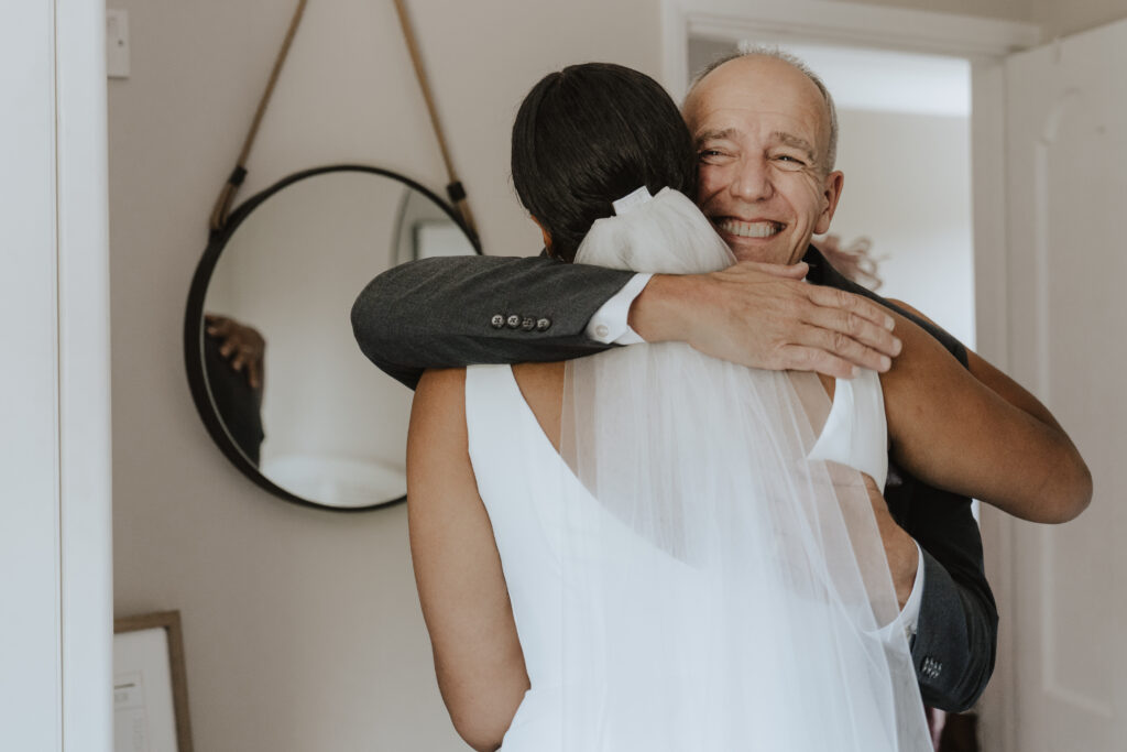 Emotional first look between bride and her father before leaving for the church