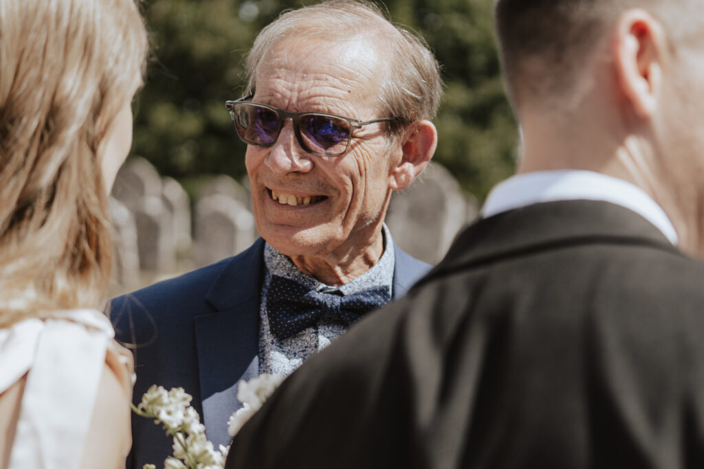 Guests enjoying homemade biscuits outside the church in the sunshine
