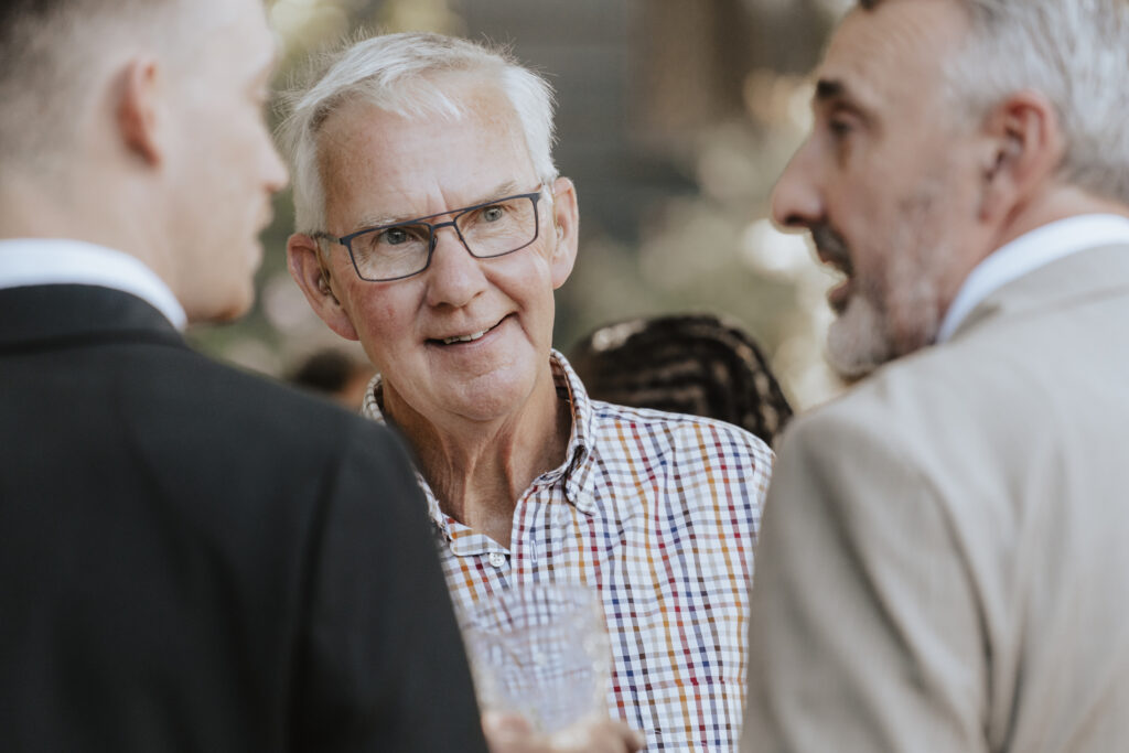 Essex wedding photographer capturing guests enjoying the drinks reception at High house in essex