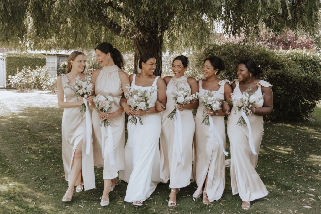Bridesmaids laughing together during candid photo moment