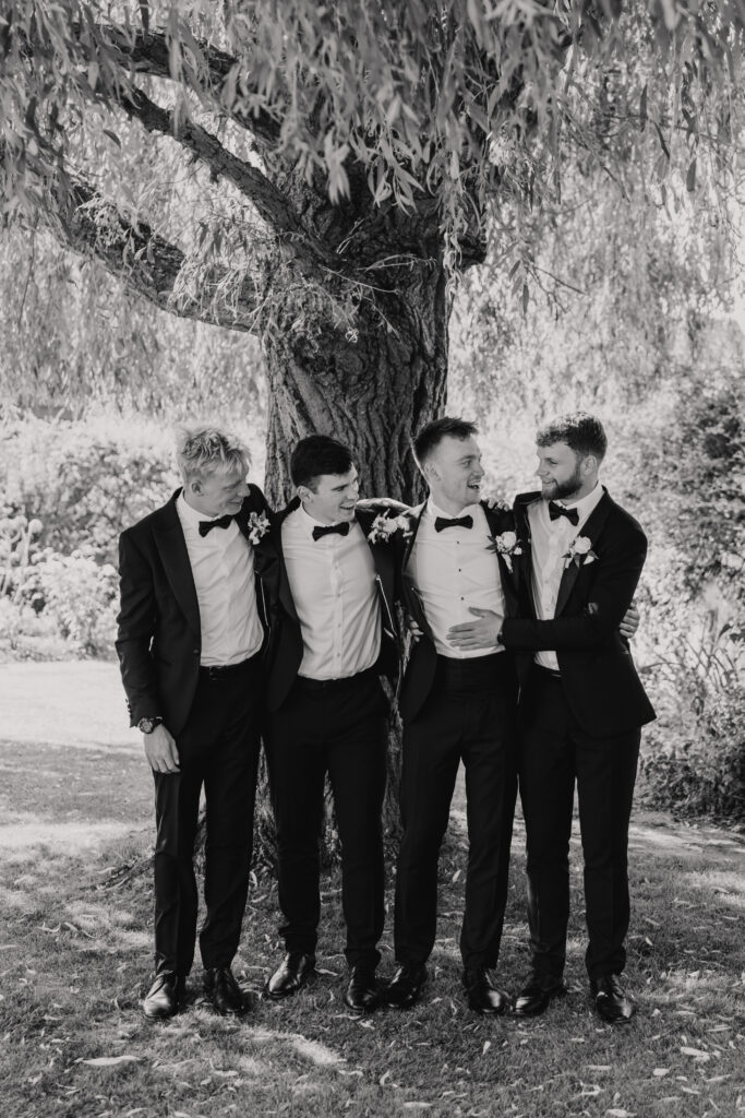 Groomsmen cheering during the drinks reception