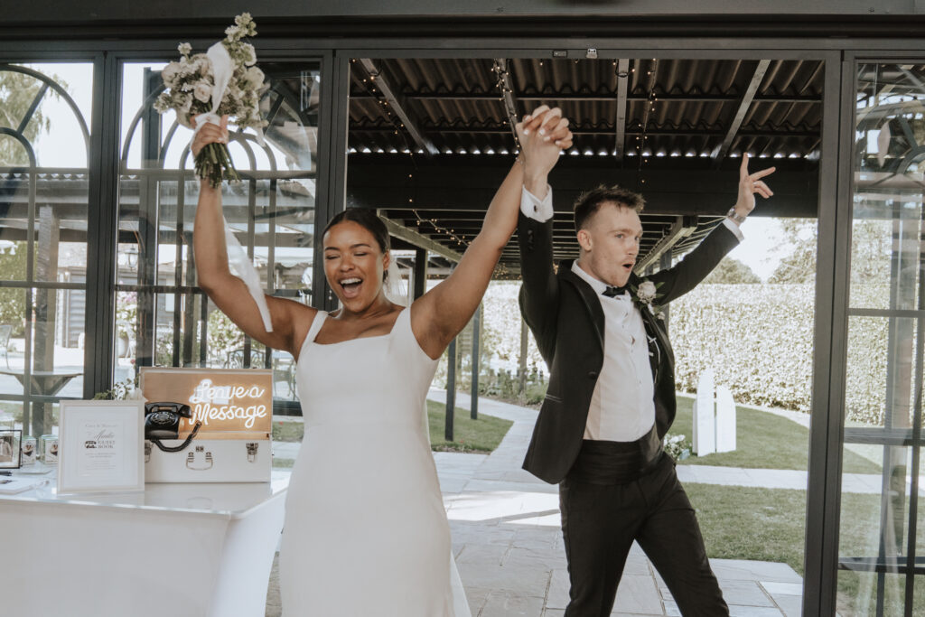Bride and groom entering the orangery at High House during the wedding breakfast