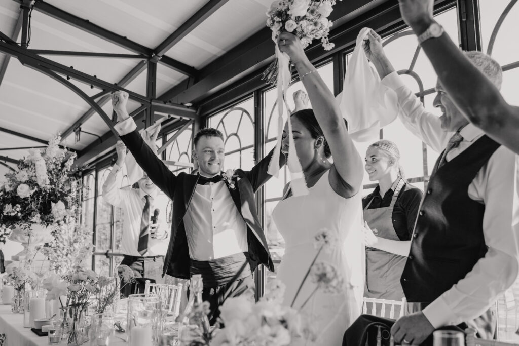 Essex wedding photographer capturing the bride and groom entering their dinner room together