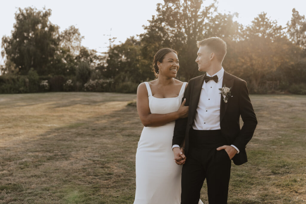 Couple walking around High House in Essex during golden hour