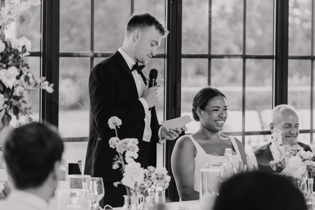 Guests standing to toast the newlyweds at High House wedding breakfast