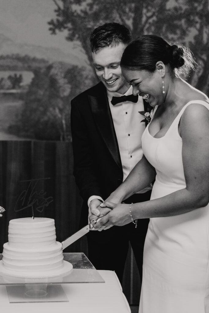 Couple cutting their wedding cake together at High House