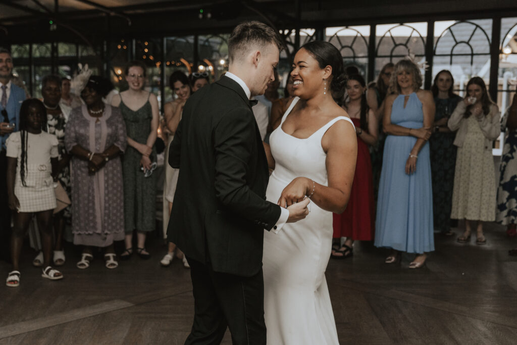 Bride and groom sharing their first dance under fairy lights