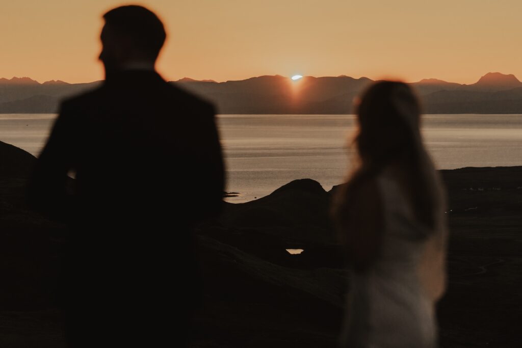 Couple standing together at the Quiraing before sunrise during their Isle of Skye elopement