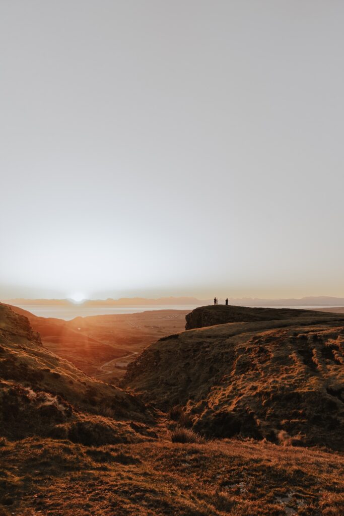 A couple during their ceremony standing together at the Quiraing before sunrise during their Isle of Skye elopement