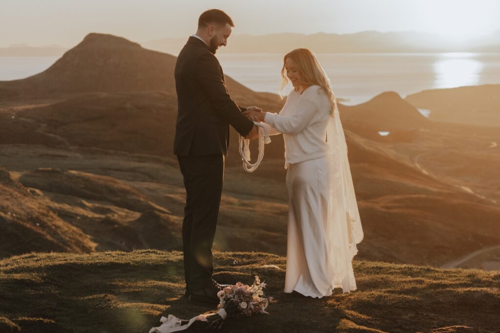 Bride and groom exchanging borrowed rings during Scotland elopement ceremony