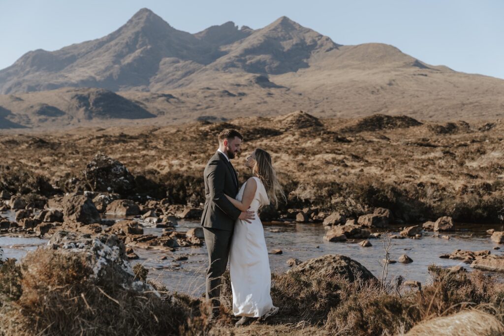 Couple by the Sligachan River with the Black Cuillin mountains in the distance