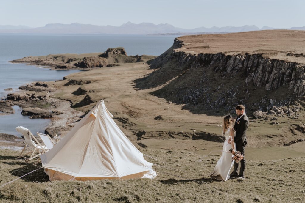 Newlyweds celebrating their Scotland elopement with champagne and laughte