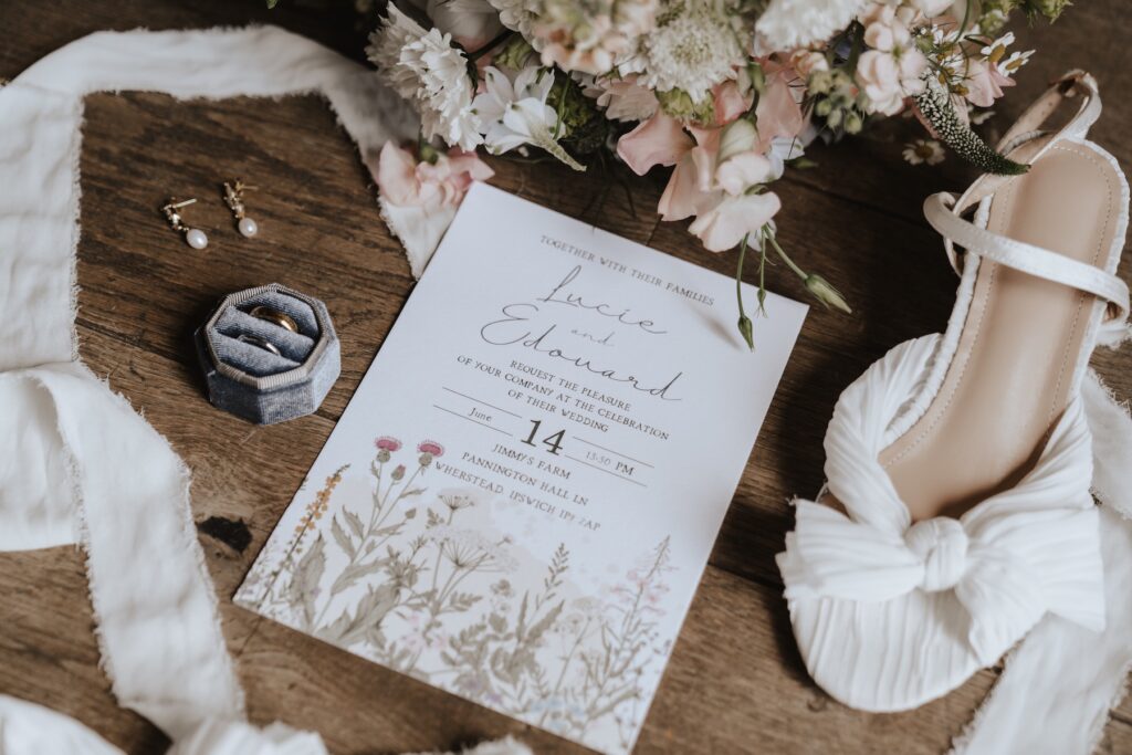 Bridal details flat lay with flowers and perfume, Suffolk wedding photography.
