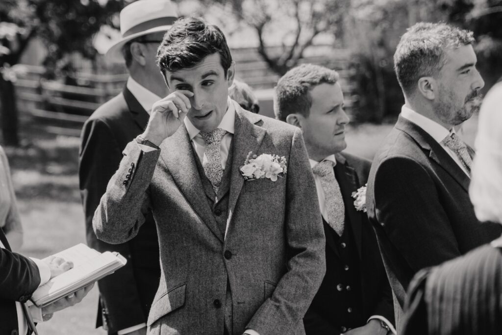 Suffolk wedding photographer capturing the groom crying during the ceremony