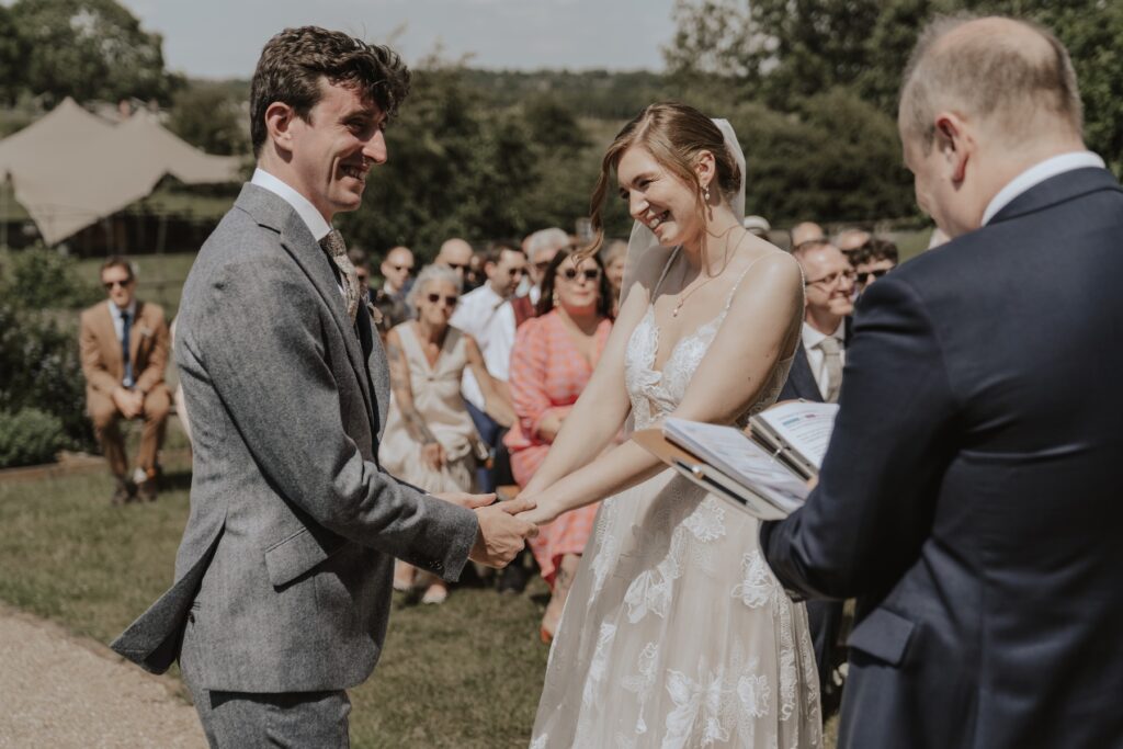 Couple exchanging vows on the steps at Jimmy’s Farm, Suffolk wedding photographer