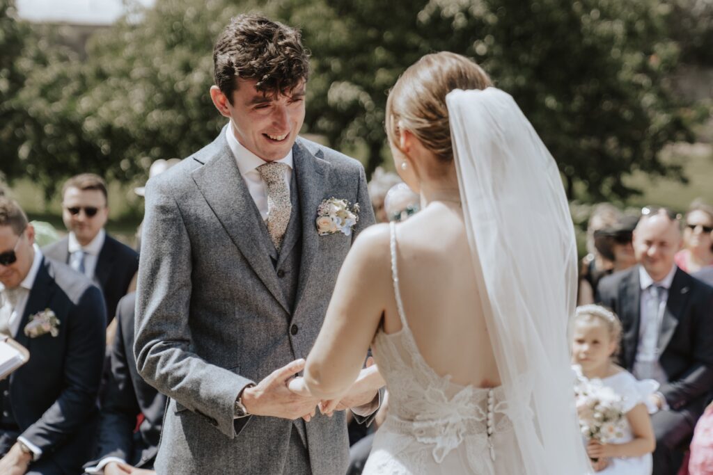 Suffolk wedding photographer capturing the couple exchanging vows on the steps at Jimmy’s Farm