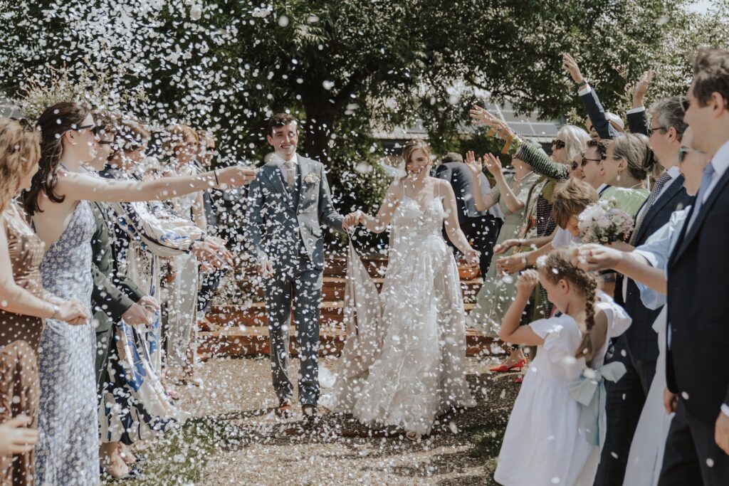 White paper confetti floating in the air during outdoor ceremony at Jimmy’s Farm