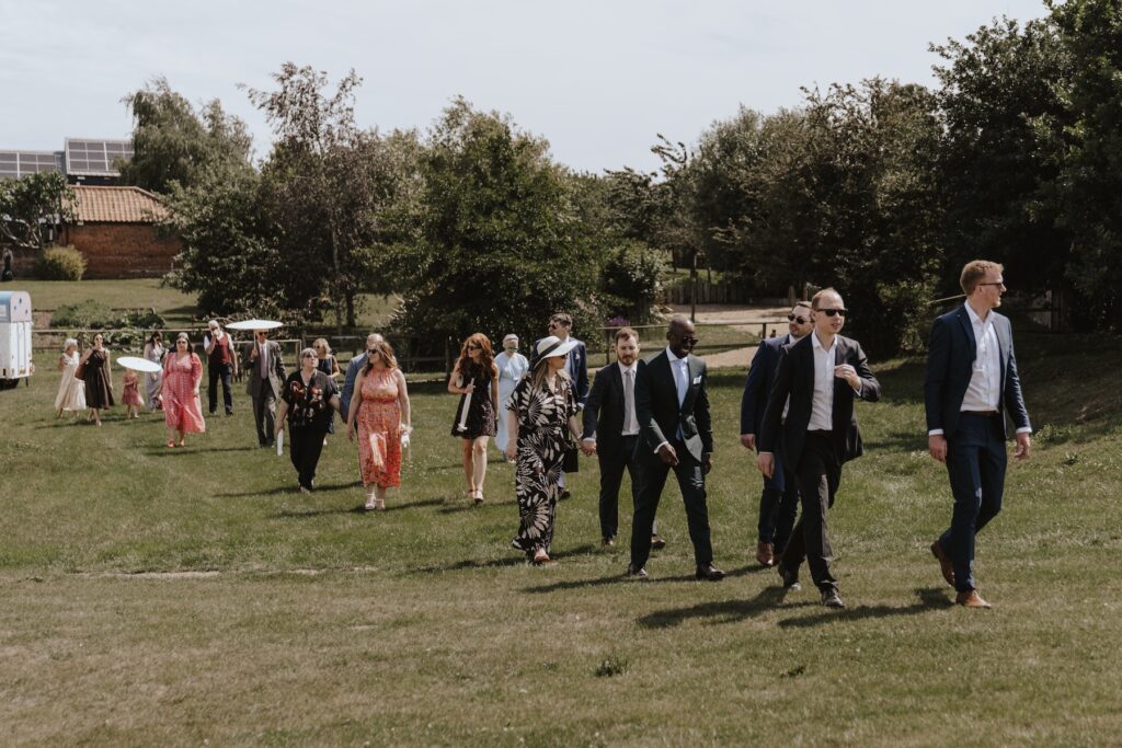 Guests enjoying drinks reception on the hill at Jimmy’s Farm wedding