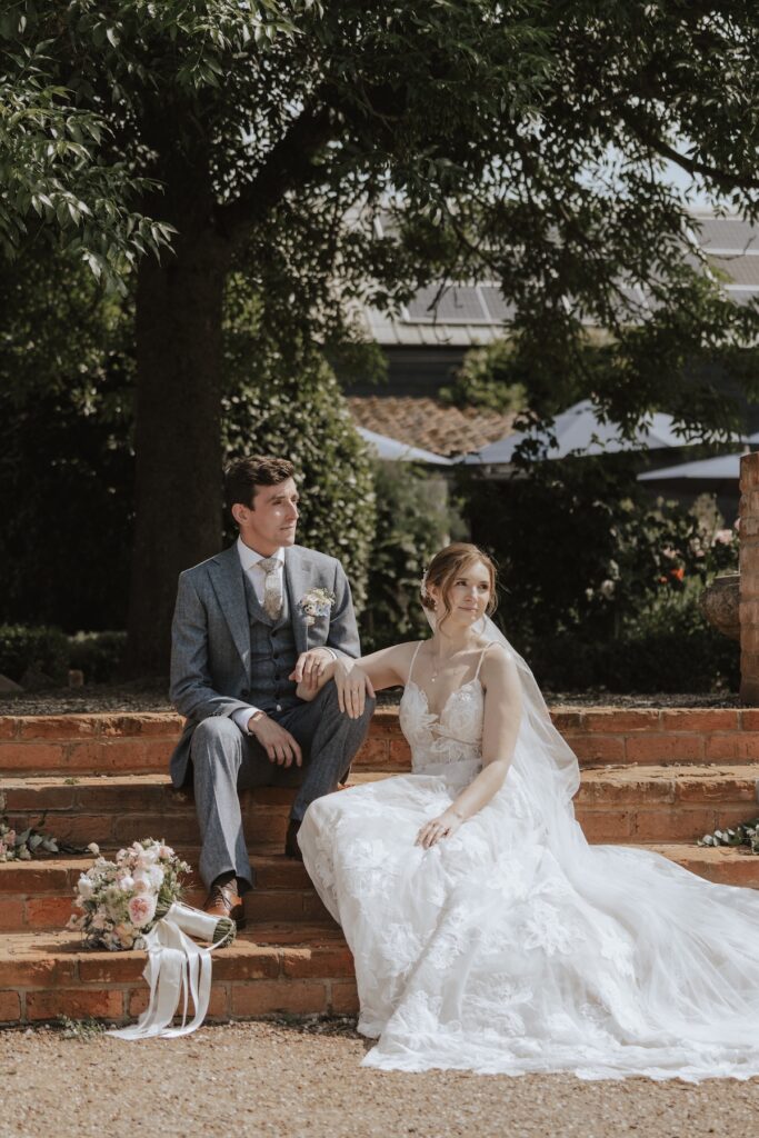 Photo of the couple at Jimmy's Farm sat on the steps