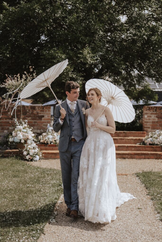 The couple getting married with parasols at Jimmy's Farm