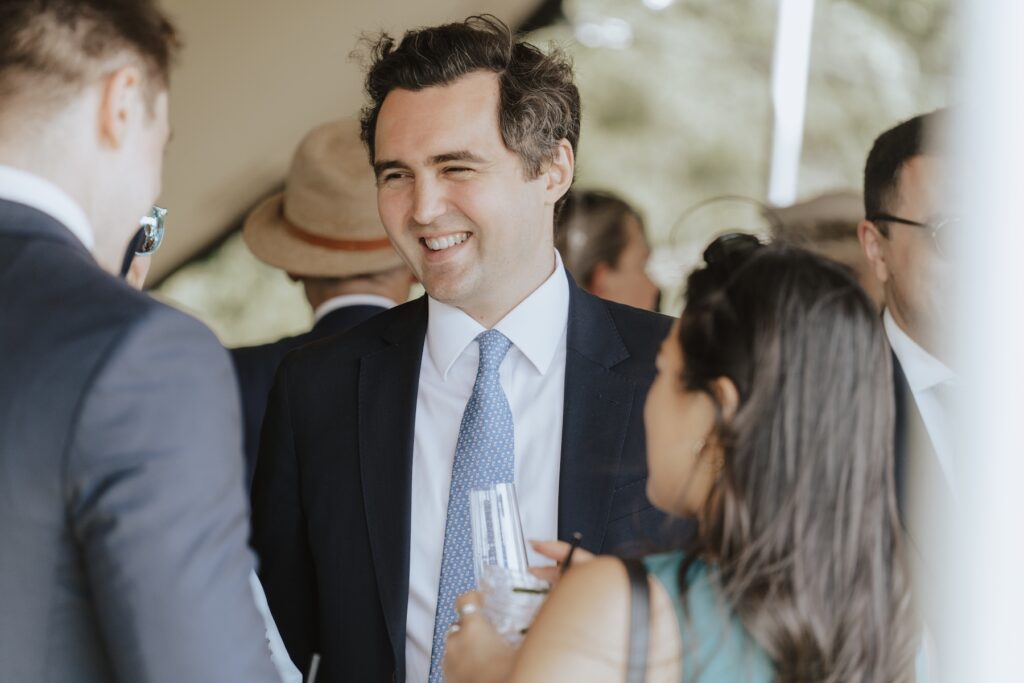 Candid laughter between friends during Suffolk wedding drinks reception