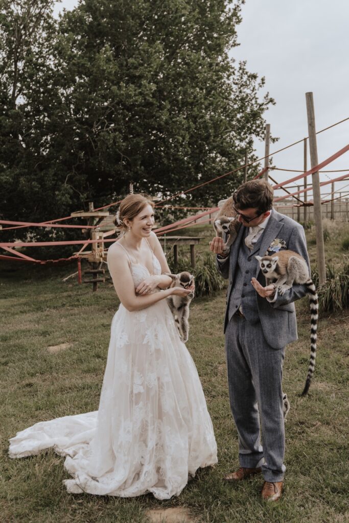 Bride and groom meeting animals during Jimmy’s Farm wedding experience at Suffolk