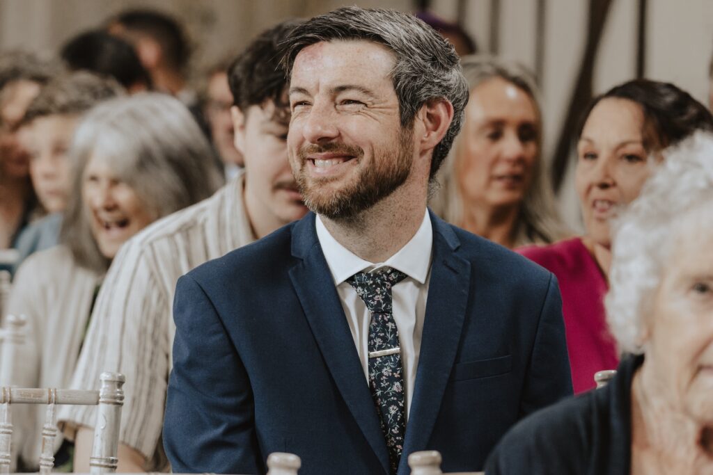 Guests smiling during heartfelt vows