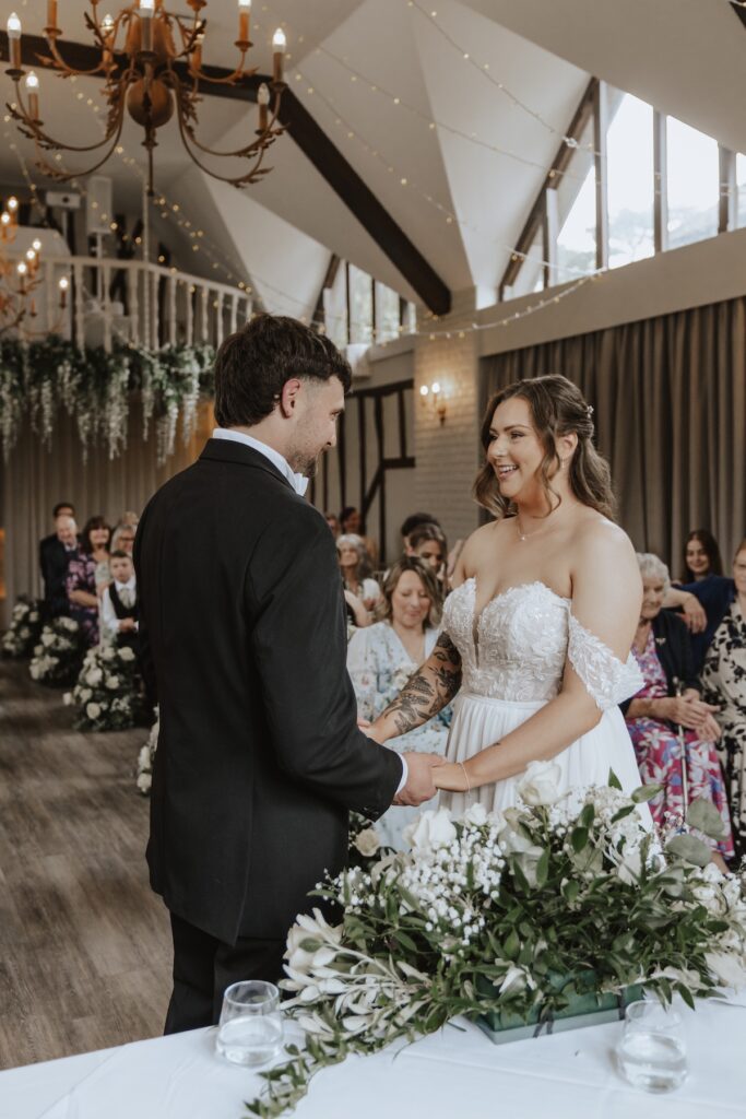 Suffolk wedding photographer capturing the bride and groom during the ceremony at Seckford Hall