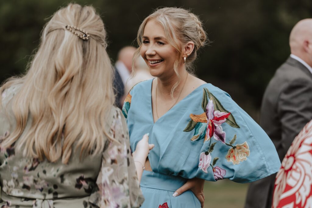 Laughter between friends during drinks reception